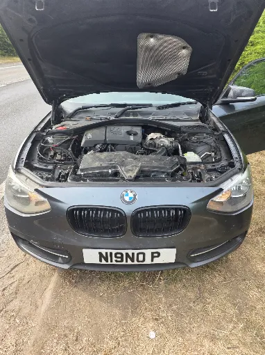 BMW with the bonnet open during a roadside diagnosis