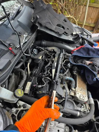 Close-up engine repair carried out on the customer's driveway
