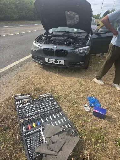 Roadside call-out with tools laid out beside the vehicle